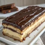 Full chocolate eclair cake with a slice missing