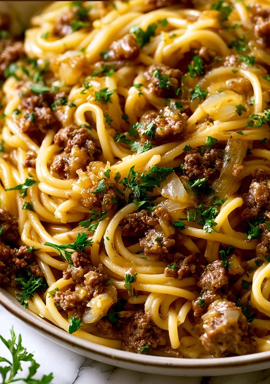 Beef Pasta with Garlic Butter served on a plate with fresh herbs